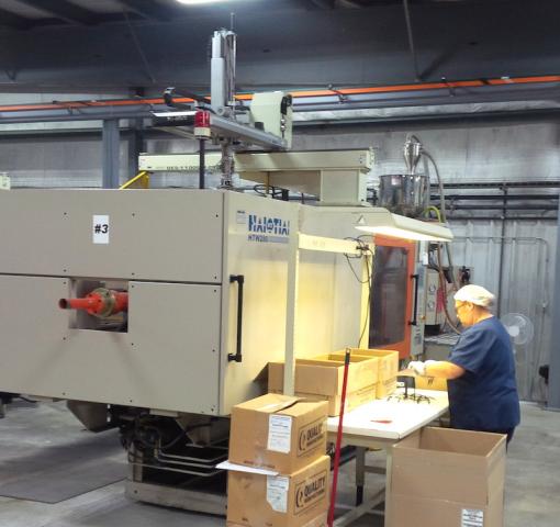 Quality Manufacturing Staff Working On Machine